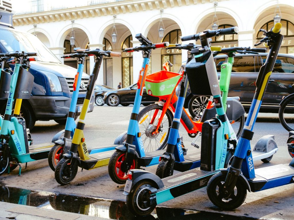 Mikromobilität in Städten: geparkte E-Scooter und Leihräder an einer Haltestelle